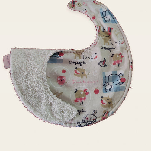 Babero impermeable 0–6 meses Animalitos franceses con una pata doblada para mostrar el rizo de algodón blanco roto