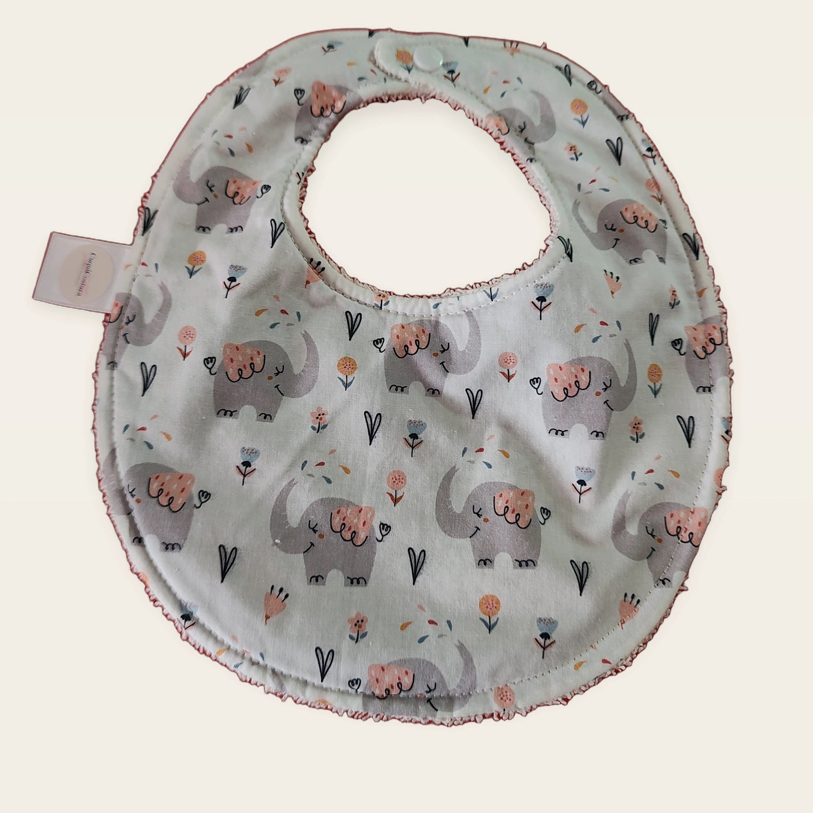 Babero impermeable 0–6 meses Cuquielefantes con rizo de algodón blanco roto, vista frontal