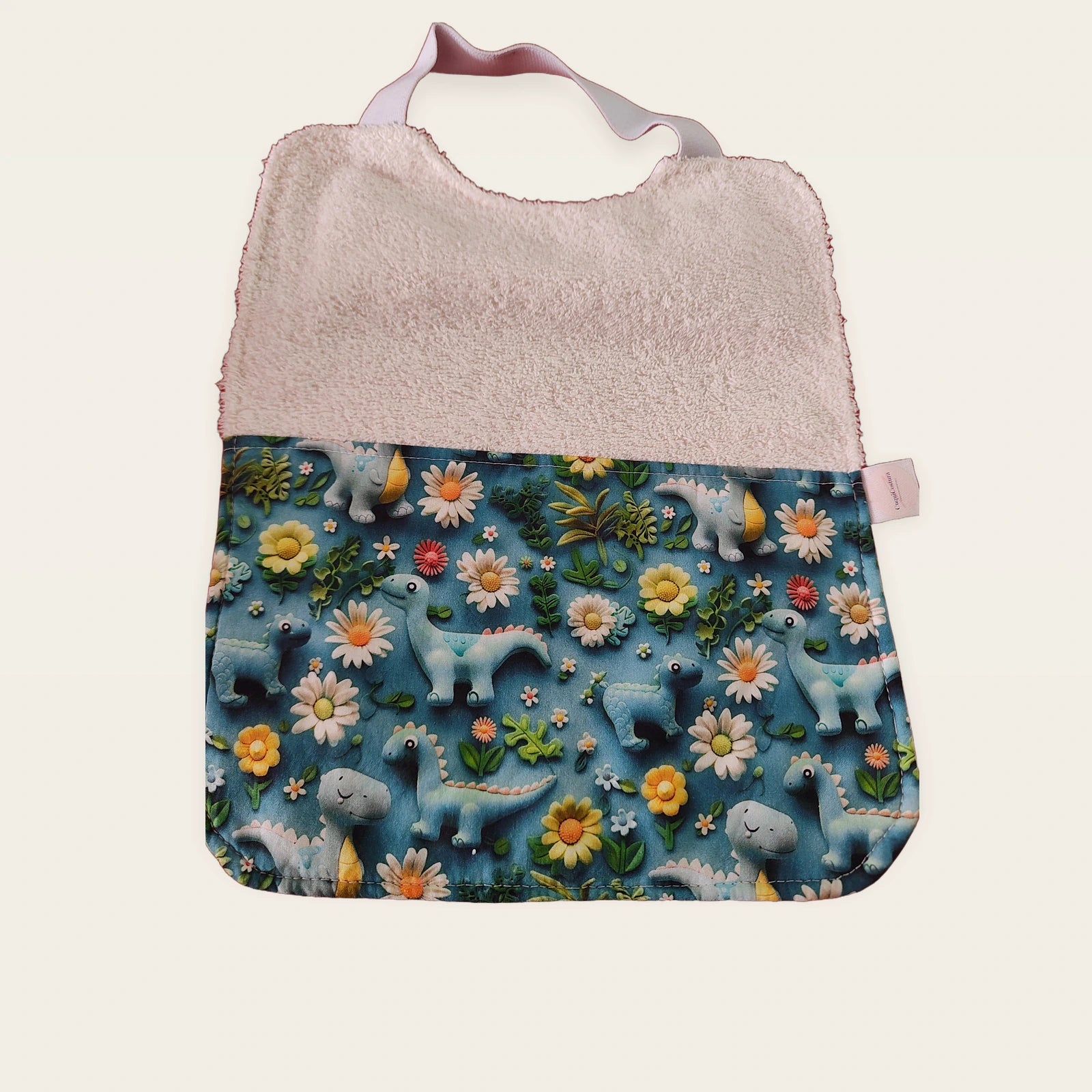 Babero infantil Dinosaurios y flores azul 3D con rizo de bambú blanco y cuello elástico